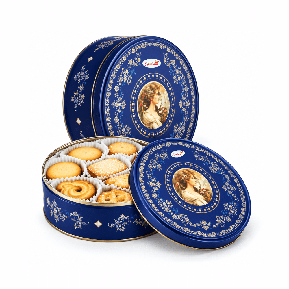 Cookies 1 Blue ornate tin filled with assorted cookies, featuring gold floral patterns and a central portrait design in the lid.